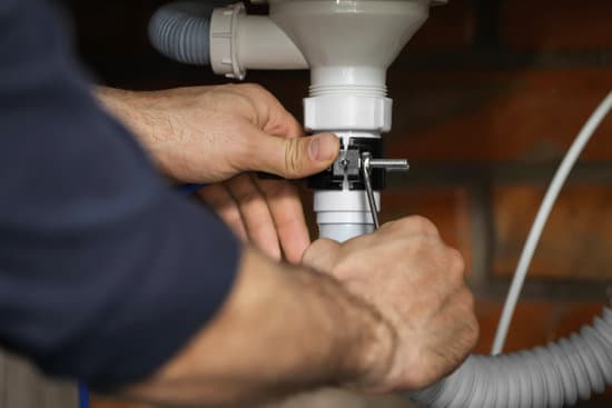 Professional plumber fixing sink, closeup