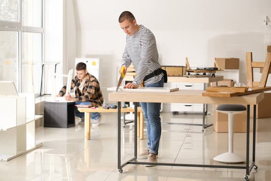 Handymen assembling furniture in workshop